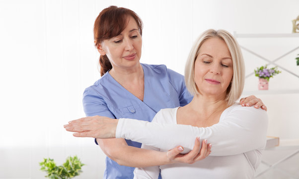 Physiotherapy, sport injury rehabilitation treatment. Woman having chiropractic back adjustment. Osteopathy, Alternative medicine, pain relief concept.