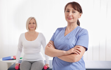 Fototapeta premium Doctor and patient in rehabilitation clinic. Closeup