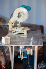 A circular saw on a workbench in an apartment. House repair, saw cut wooden products