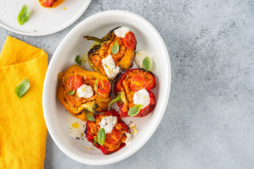 Bell peppers stuffed with meat, vegetables, and cheese, top view.