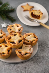 Delicious fruit mince tarts for Christmas dinner. Grey background, selective focus