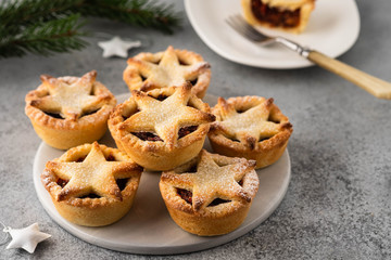 Delicious fruit mince tarts for Christmas dinner. Grey background, selective focus