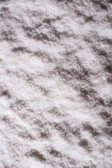 Texture and background of night snow. Top view. Winter. Copy space. Vertical ratio