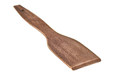 Single old scratched wooden spatula of brown color isolated on white background without shadow. Close-up