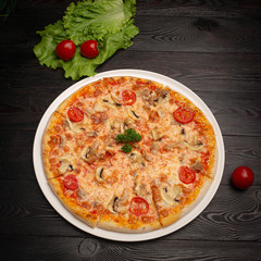 assorted pizza sliced into pieces with cheese, tomato and olives