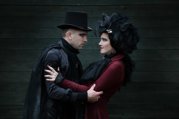 Passionate young couple dressed in old fashioned vampire style clothes