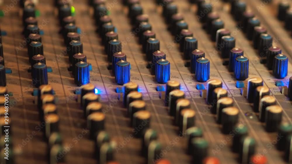 Poster professional audio mixing console, mixer. pro audio mixing board faders and knobs. static shot of mu