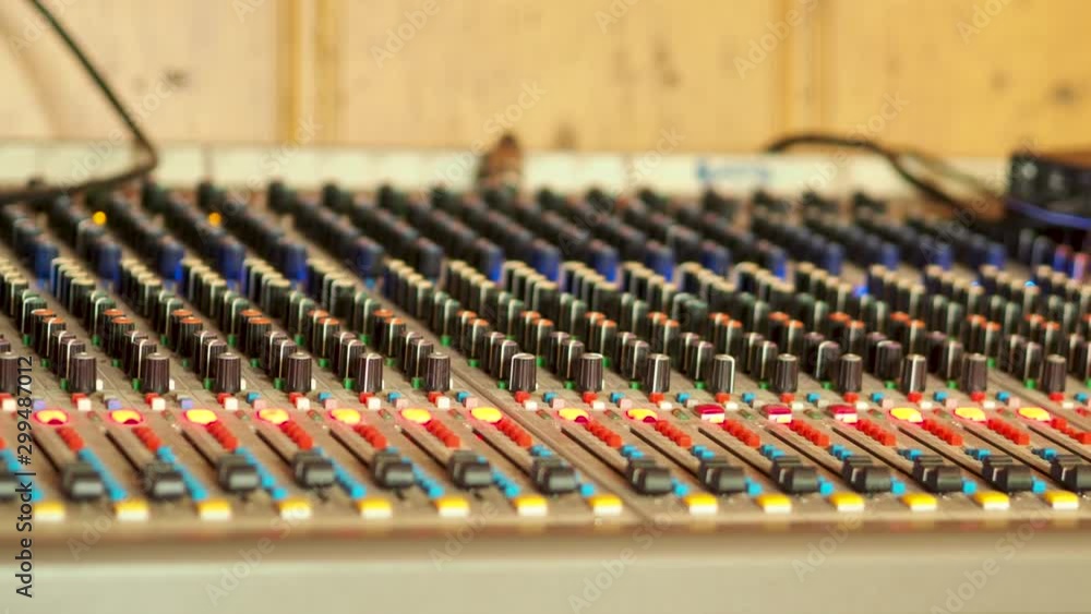 Poster professional audio mixing console, mixer. pro audio mixing board faders and knobs. static shot of mu