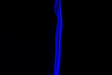 blue smoke from aromatic sticks on a black background