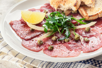 Beef carpaccio with arugula and parmesan