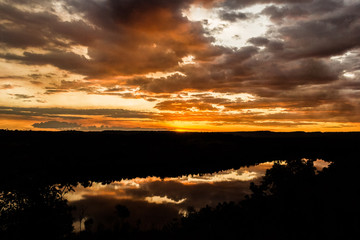 Fototapeta na wymiar shot through tress of a beautiful sunset in the australian outback with 1 lakes, Nitmiluk National Park, Australia
