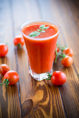 homemade tomato juice in a glass and fresh tomatoes