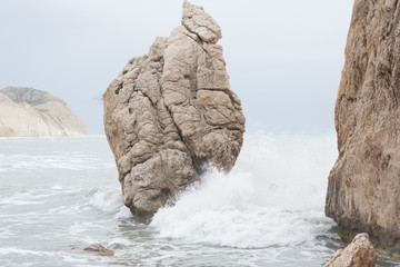 Wave splashes against Aphrodite's Rock, Cyprus.