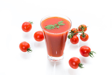 homemade tomato juice in a glass and fresh tomatoes