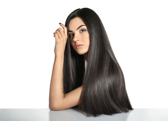 Portrait of beautiful young woman with healthy long hair on white background