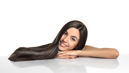 Portrait of beautiful young woman with healthy long hair on white background