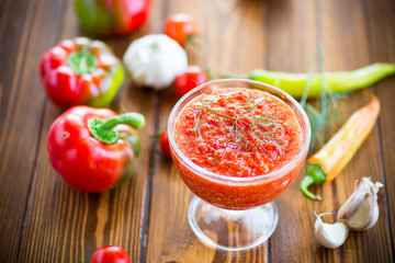 homemade hot adjika from tomatoes, hot and sweet peppers with spices