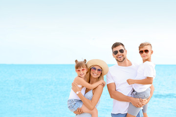 Portrait of happy family on sea beach