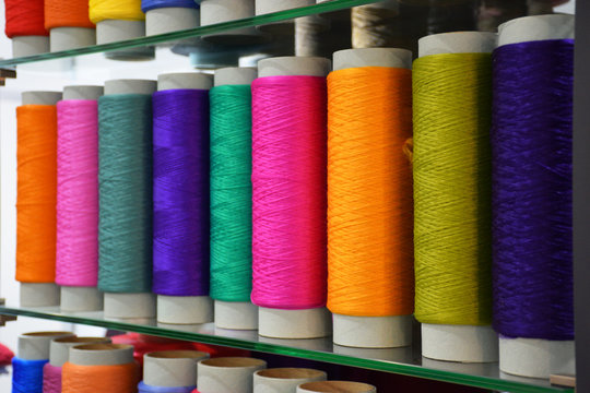 Multicolored bobbin thread. Large colorful polypropylene threads set in rainbow mood. Polypropylene multifilament yarns. Set of sewing thread coils, miscellaneous colours.