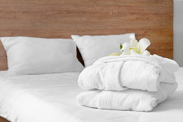 Fototapeta na wymiar Soft clean bathrobes on bed