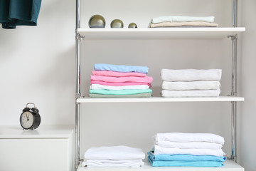 Stacked clean clothes on shelves in show room