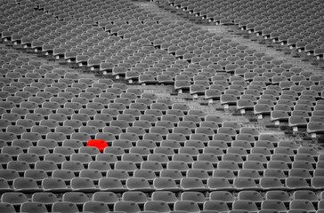 Football stadium with empty seats. Outstanding empty red plastic chair at soccer arena. Row of...