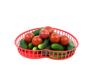 Cucumbers and tomatoes in a basket on a white background