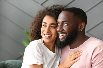 Fototapeta premium Portrait of happy African-American couple at home