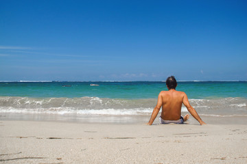 A man sitting on the beach