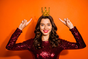 Portrait of charming luxurious prom queen beauty girl point index finger her golden tiara direct royal status wear modern stylish classy outfit isolated over orange color background