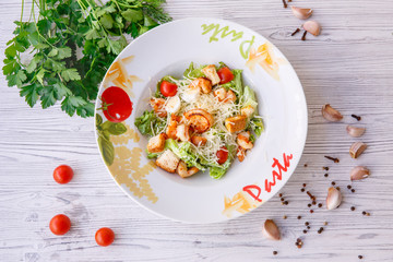 Caesar salad with seafood, the plate says pasta.