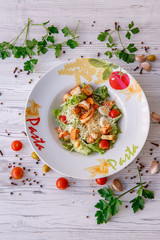 Caesar salad with seafood, the plate says pasta.