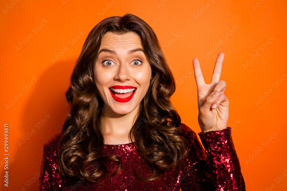 Wall mural Close-up portrait of her she nice attractive gorgeous lovely pretty girlish funky cheerful cheery wavy-haired girl showing v-sign isolated over bright vivid shine vibrant orange color background