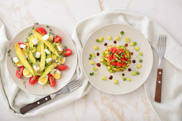 Plates with healthy salads on table