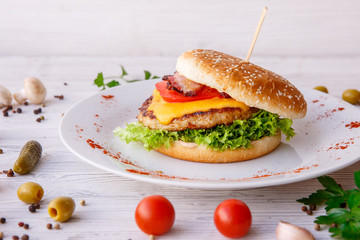 Burger on wooden light background, fast food, street food
