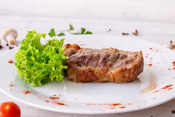 steak on a white plate