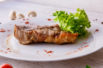 steak on a white plate