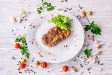 steak on a white plate
