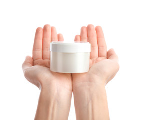 Hands of young woman with cream on white background