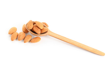 Spoon with tasty almonds on white background