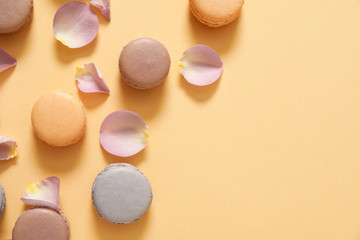 Tasty macarons on color background