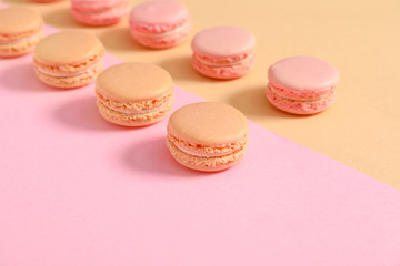 Tasty macarons on color background