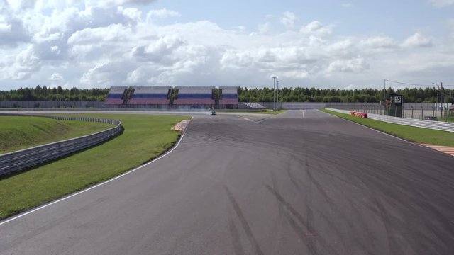 Aerial view racing car training on speed rack. Drone view japanese jdm drift car riding on racing track. Driver driving on racing car at track