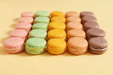 Tasty macarons on color background