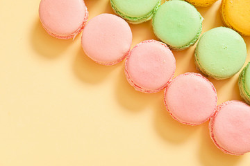Tasty macarons on color background