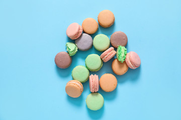 Tasty macarons on color background