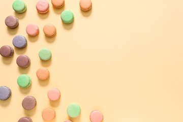 Tasty macarons on color background