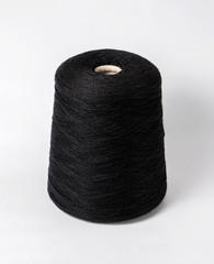 bobbin of yarn on a white background. Side view.Textile reel on isolated white background.