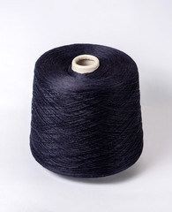 bobbin of yarn on a white background. Side view.Textile reel on isolated white background.