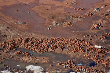 Rusty fuel and chemical drums in the Arctic – aerial view